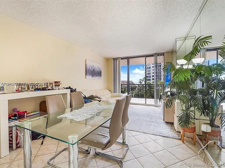 540 Brickell Key Drive, Unit 603 Miami, FL 33131 - Photo 2 of 18 a dining room with furniture and a floor to ceiling window