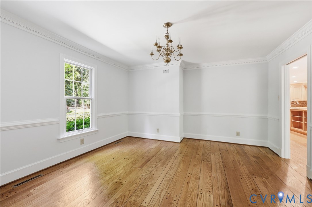 3201 East Brigstock Road Midlothian, VA 23113 - Photo 23 of 72 an empty room with wooden floor and windows