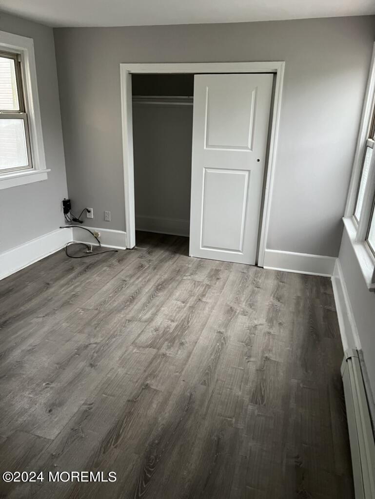 615 2nd Avenue, Unit 1 Asbury Park, NJ 07712 - Photo 12 of 39 an empty room with wooden floor and window