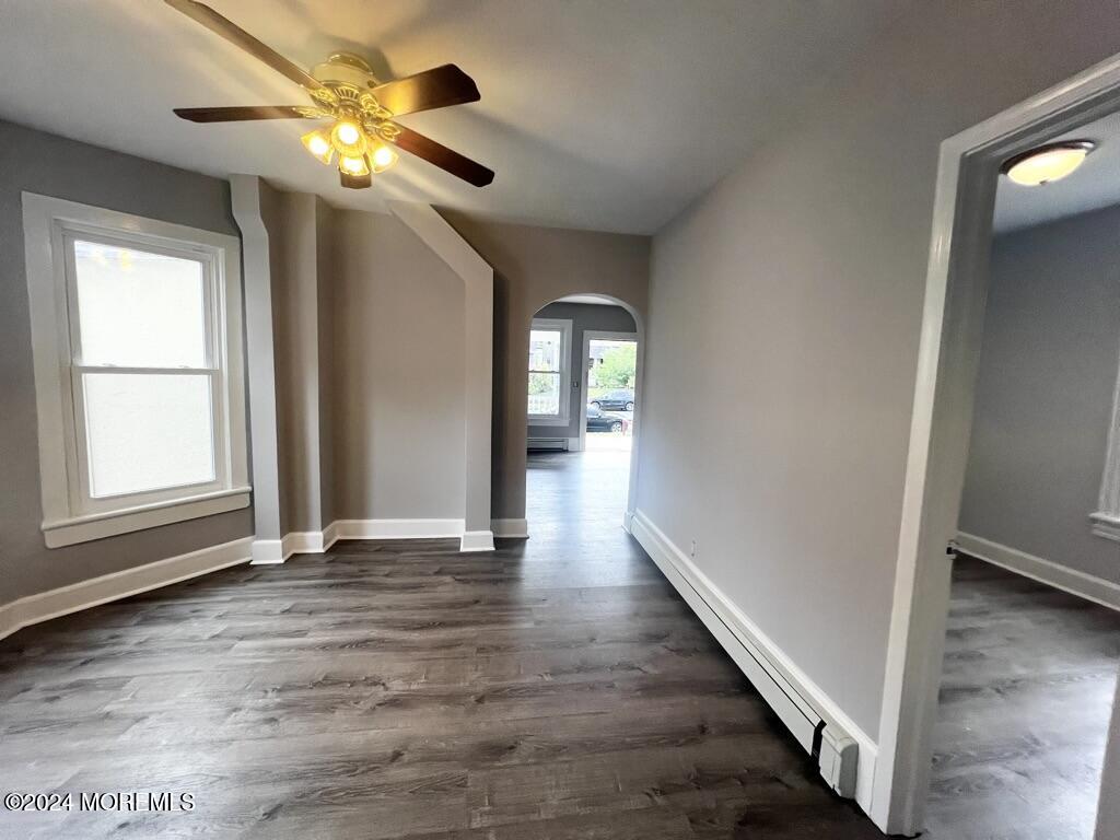 615 2nd Avenue, Unit 1 Asbury Park, NJ 07712 - Photo 15 of 39 an empty room with wooden floor and windows