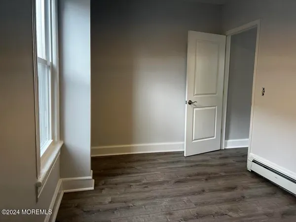 an empty room with wooden floor