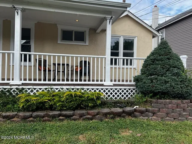 a view of a house with wooden fence
