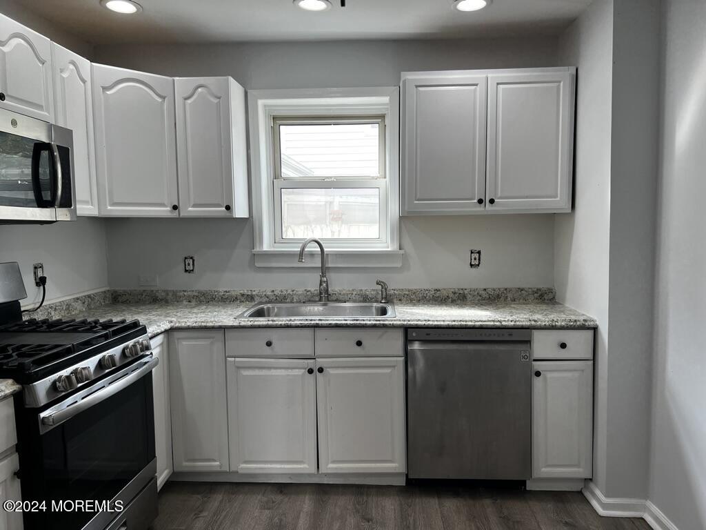 615 2nd Avenue, Unit 1 Asbury Park, NJ 07712 - Photo 22 of 39 a kitchen with stainless steel appliances granite countertop a sink stove and microwave