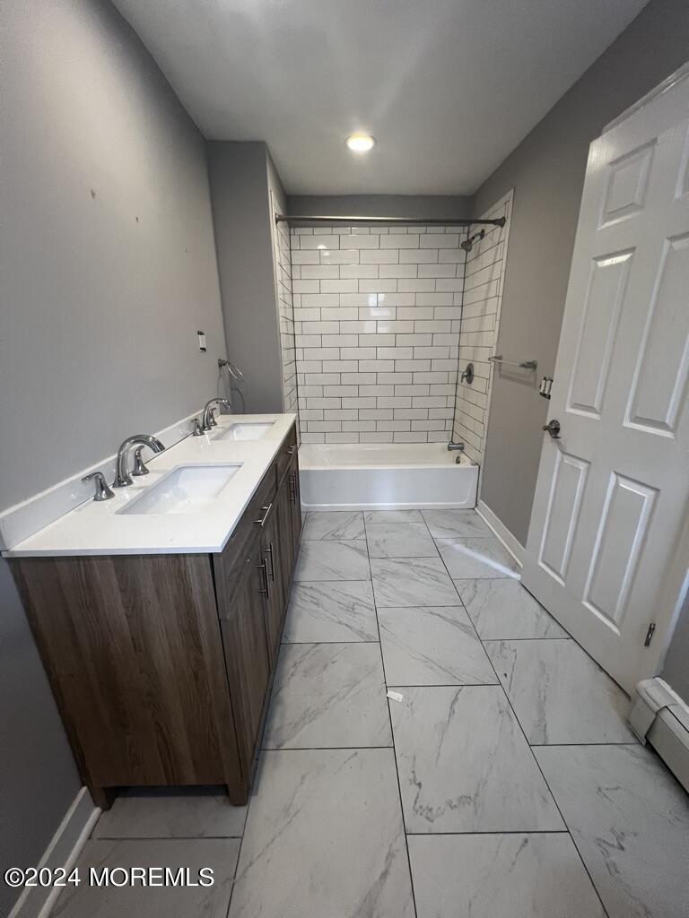 615 2nd Avenue, Unit 1 Asbury Park, NJ 07712 - Photo 26 of 39 a bathroom with a sink a toilet and shower