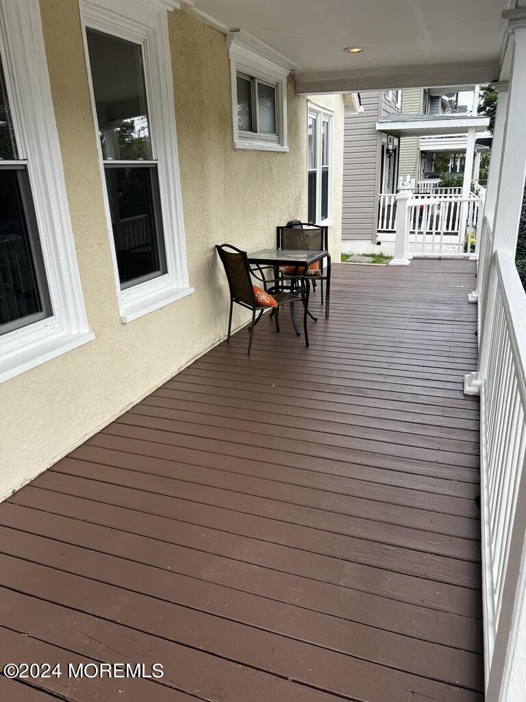 615 2nd Avenue, Unit 1 Asbury Park, NJ 07712 - Photo 3 of 39 a view of a patio with table and chairs and wooden floor