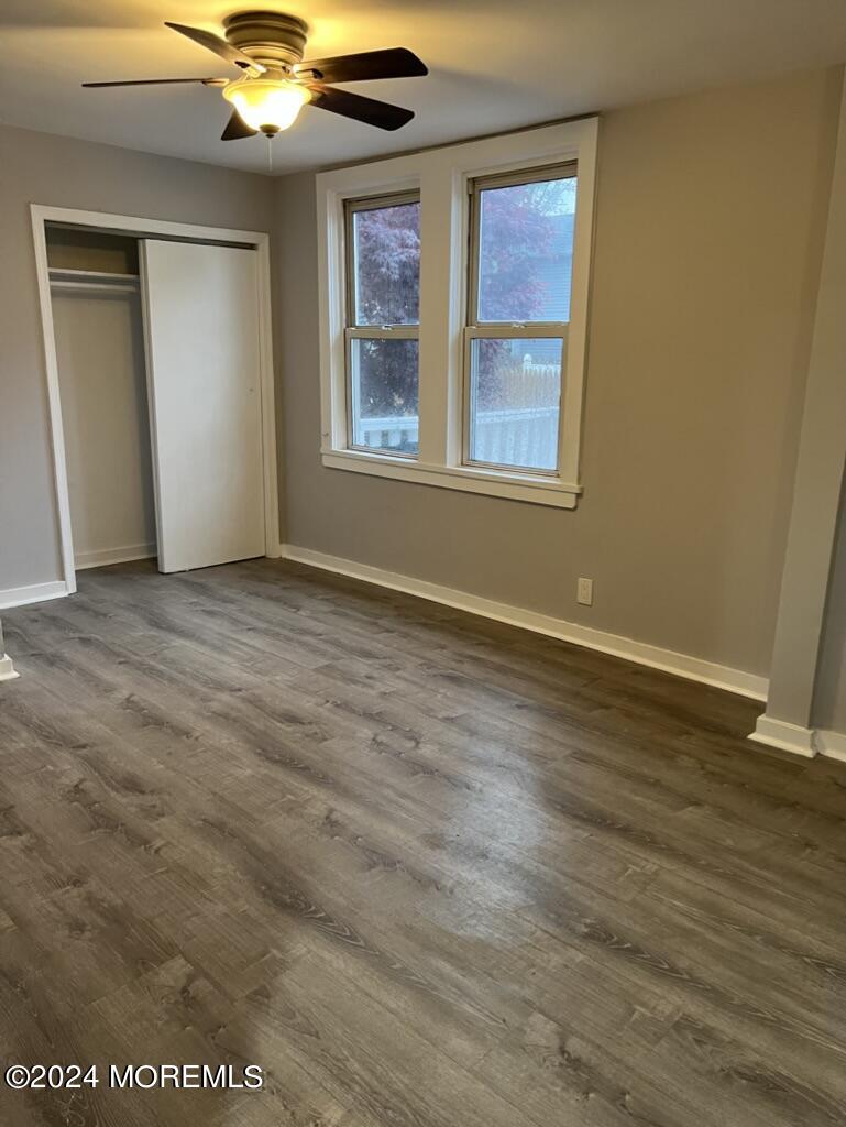 615 2nd Avenue, Unit 1 Asbury Park, NJ 07712 - Photo 32 of 39 an empty room with wooden floor fan and windows