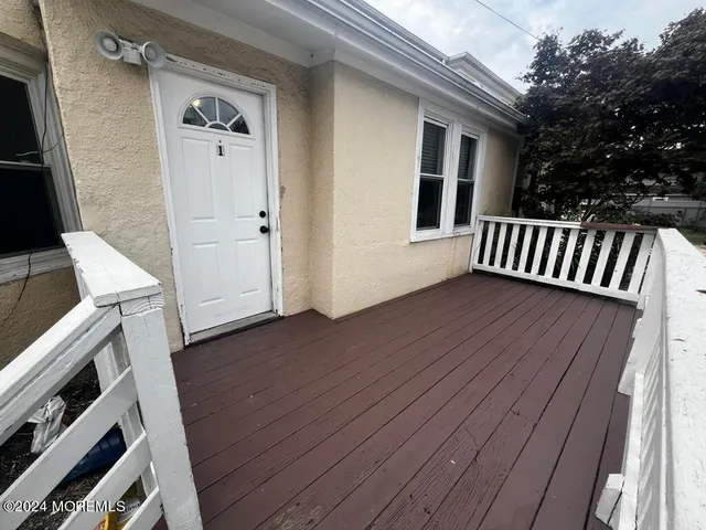 an empty room with wooden floor and a window