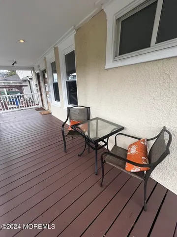 a workspace with wooden floor and furniture