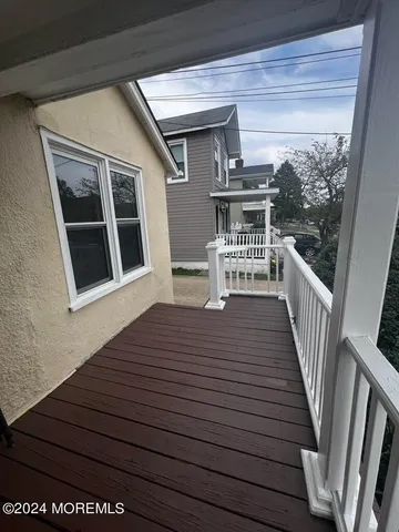 a view of a house with wooden deck