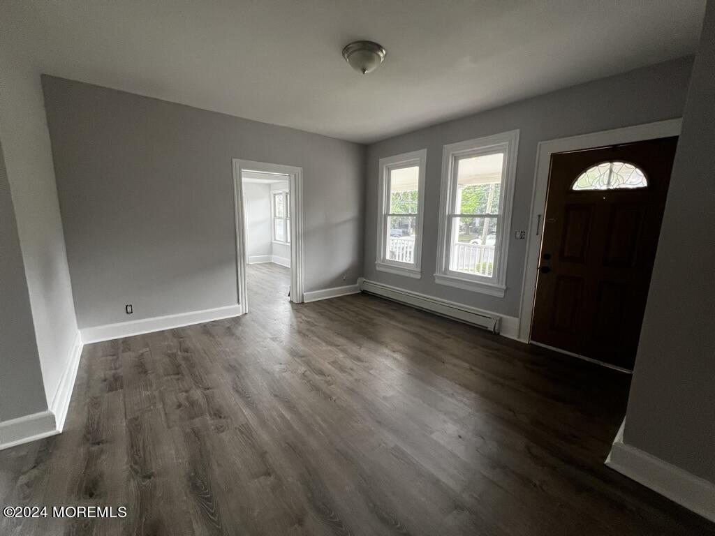 615 2nd Avenue, Unit 1 Asbury Park, NJ 07712 - Photo 6 of 39 an empty room with wooden floor and windows