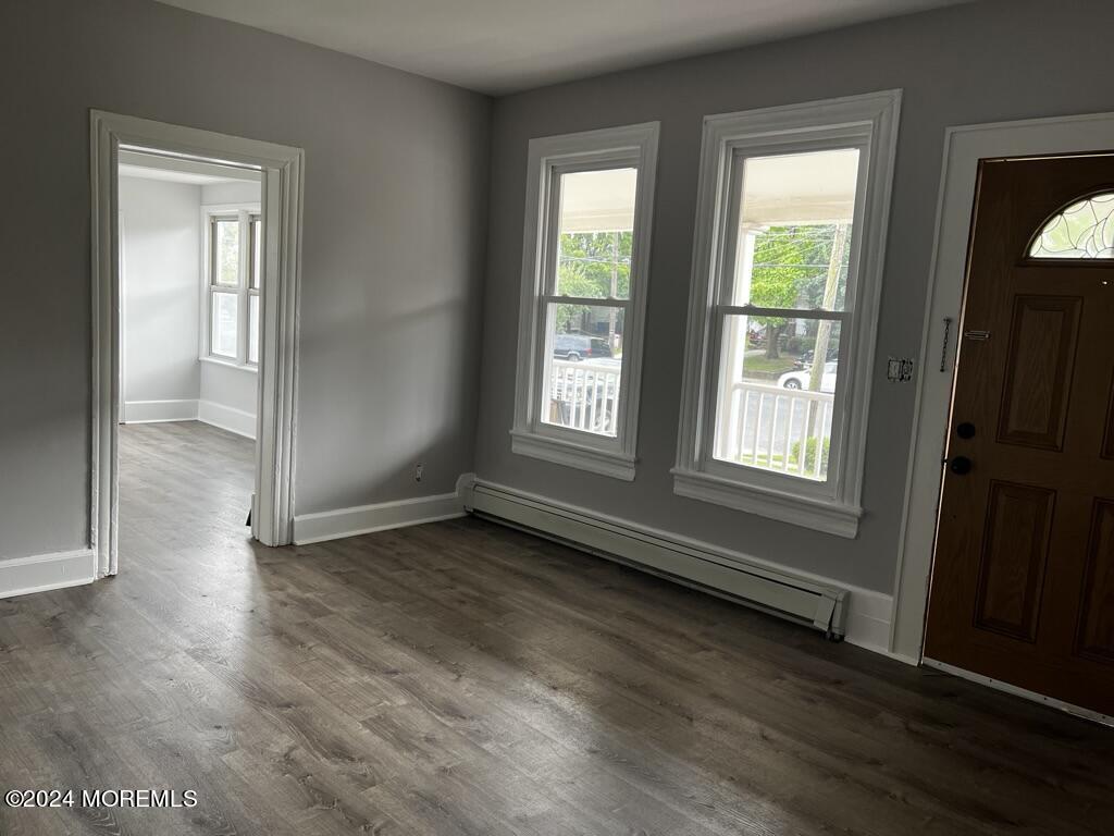 615 2nd Avenue, Unit 1 Asbury Park, NJ 07712 - Photo 8 of 39 an empty room with wooden floor and windows