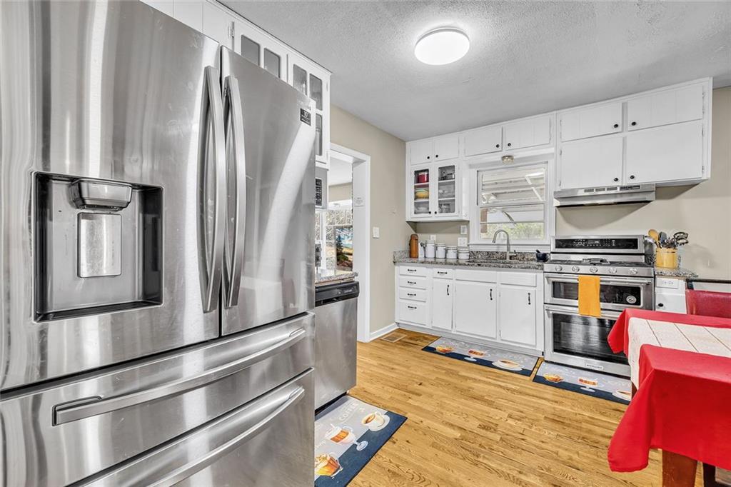 349 Virginia Place Southeast Marietta, GA 30067 - Photo 14 of 37 a kitchen with stainless steel appliances granite countertop a refrigerator and a stove top oven