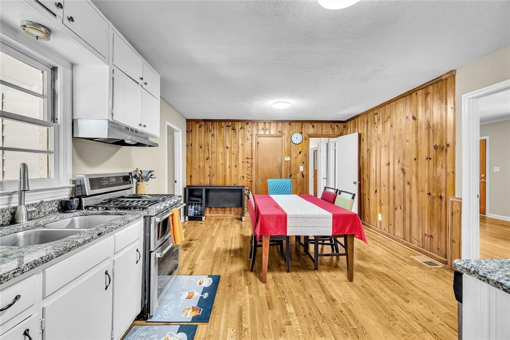 349 Virginia Place Southeast Marietta, GA 30067 - Photo 16 of 37 a kitchen with a stove a sink dishwasher and a refrigerator with wooden floor