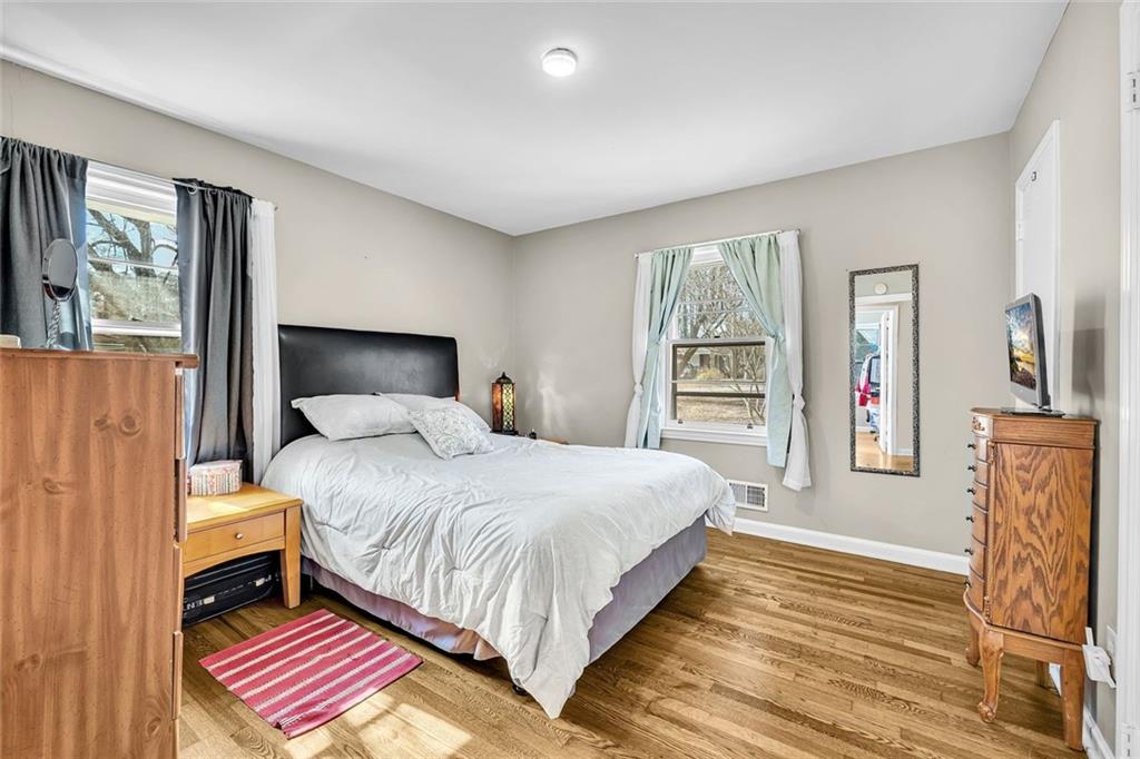 349 Virginia Place Southeast Marietta, GA 30067 - Photo 25 of 37 a bedroom with a large bed a fireplace and a window