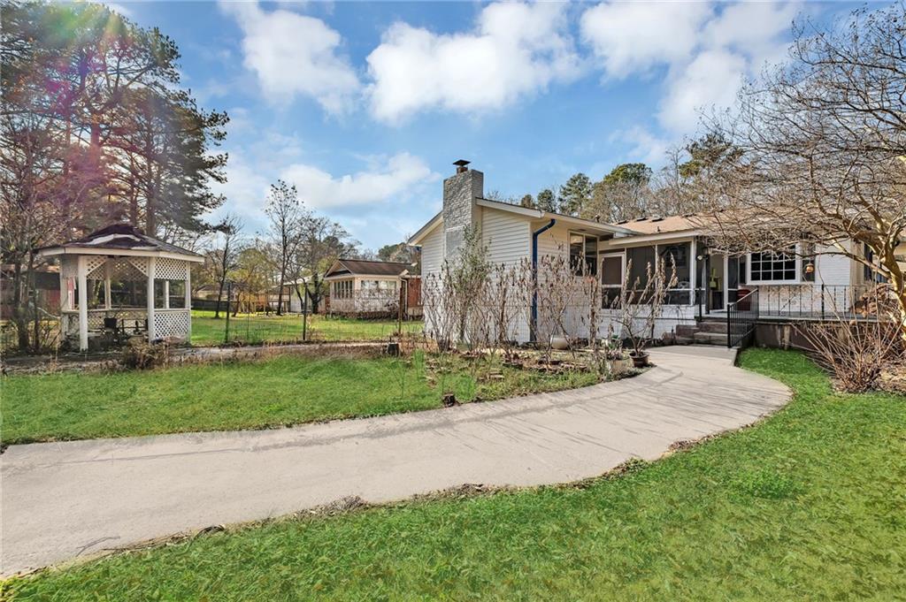 349 Virginia Place Southeast Marietta, GA 30067 - Photo 32 of 37 a front view of a house with a yard and many windows