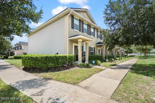 a front view of a house with a yard