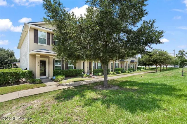 a front view of a house with a yard
