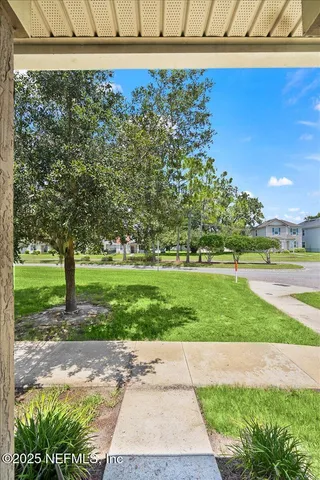 a view of a yard with yellow house