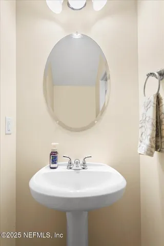 a bathroom with a sink and mirror
