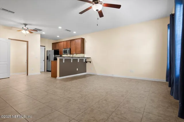 a view of kitchen with refrigerator and window
