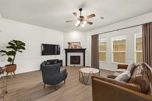 a living room with furniture a fireplace and a flat screen tv