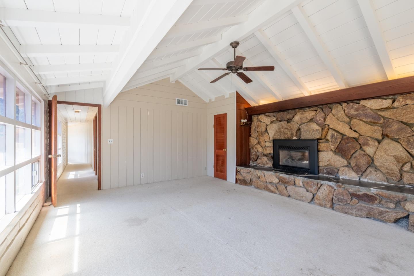 72 Los Laureles Grade Road Carmel Valley, CA 93924 - Photo 5 of 43 a view of an empty room with a fireplace and a window