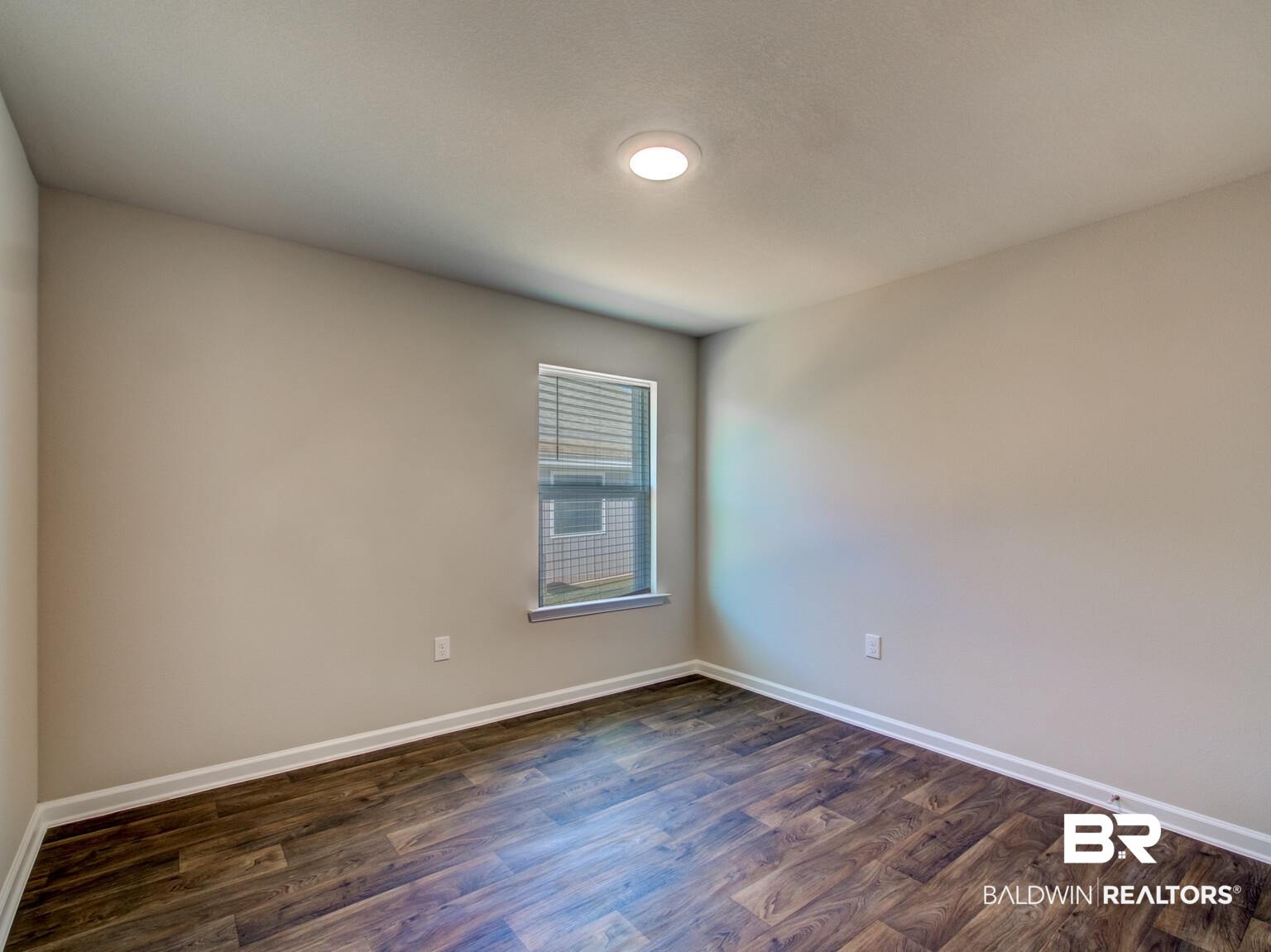 23952 Citation Loop Daphne, AL 36526 - Photo 34 of 69 Empty room with dark wood finished floors and baseboards
