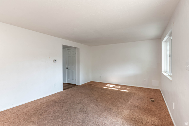 728 400 East Orem, UT 84097 - Photo 16 of 30 Room featuring neutral wall tones, brown carpet flooring, and a single pane window