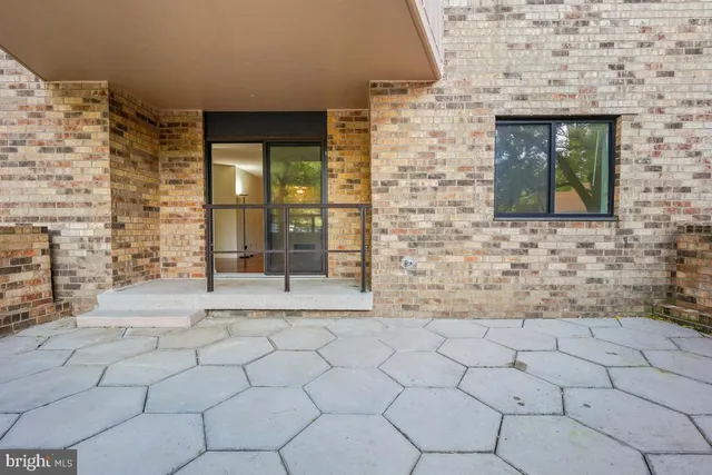 a view of a room with wooden floor and a ceiling fan