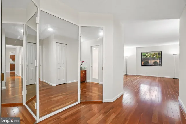 a living room with furniture and a view of kitchen