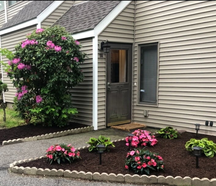 51 Brook Street, Unit 5A Naugatuck, CT 06770 - Photo 1 of 15 a house view with a flower garden