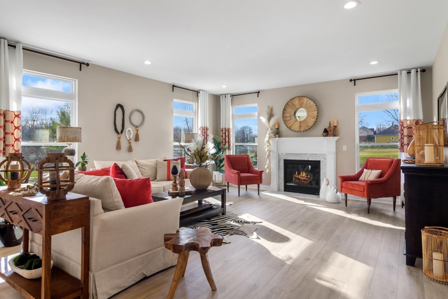 8772 Potomac Way Lowell, IN 46356 - Photo 11 of 22 a living room with furniture a clock and a fireplace