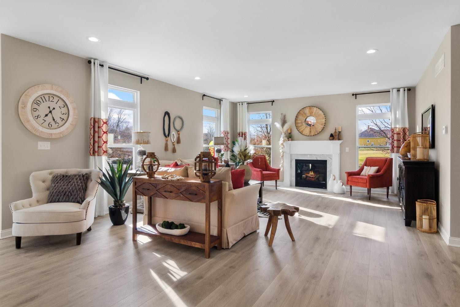 8772 Potomac Way Lowell, IN 46356 - Photo 9 of 22 a living room with furniture a clock and a fireplace