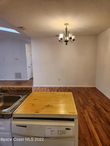 a kitchen with stainless steel appliances a sink a stove a microwave a sink and cabinets