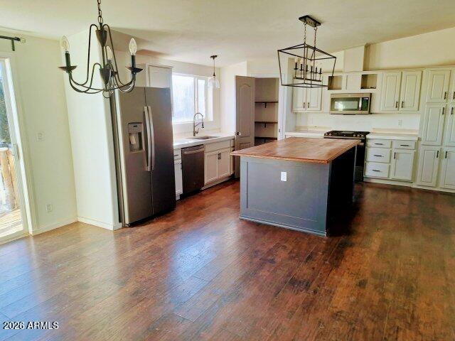 1595 Bourdon Ranch Road Show Low, AZ 85901 - Photo 11 of 41 a kitchen with stainless steel appliances granite countertop a refrigerator a sink a stove a microwave and wooden floors