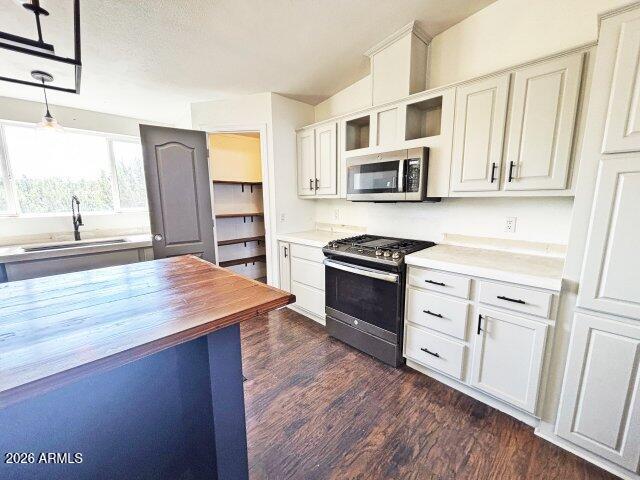 1595 Bourdon Ranch Road Show Low, AZ 85901 - Photo 12 of 41 a kitchen with stainless steel appliances a stove microwave and cabinets
