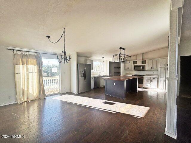 1595 Bourdon Ranch Road Show Low, AZ 85901 - Photo 16 of 41 a large kitchen with stainless steel appliances kitchen island granite countertop a refrigerator a stove and a wooden floors