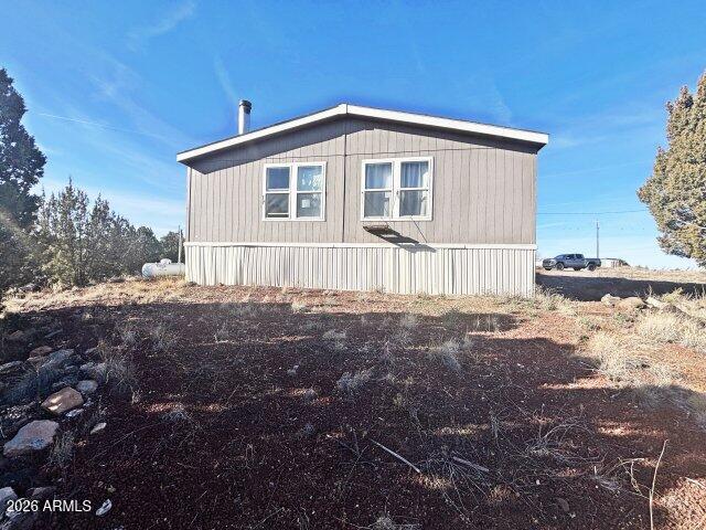 1595 Bourdon Ranch Road Show Low, AZ 85901 - Photo 38 of 41 a front view of a house with a yard