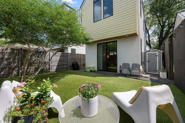 a view of a house with backyard sitting area and garden