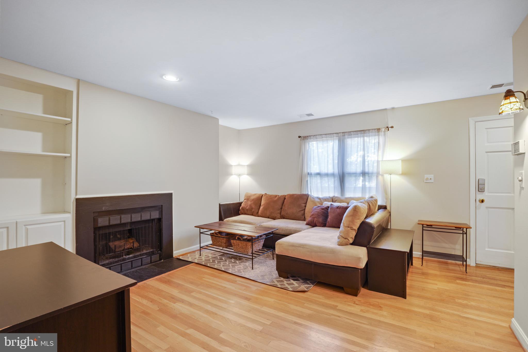 4202 Roland Avenue, Unit 202 Baltimore, MD 21211 - Photo 5 of 29 Living Room W/ wood burning FP