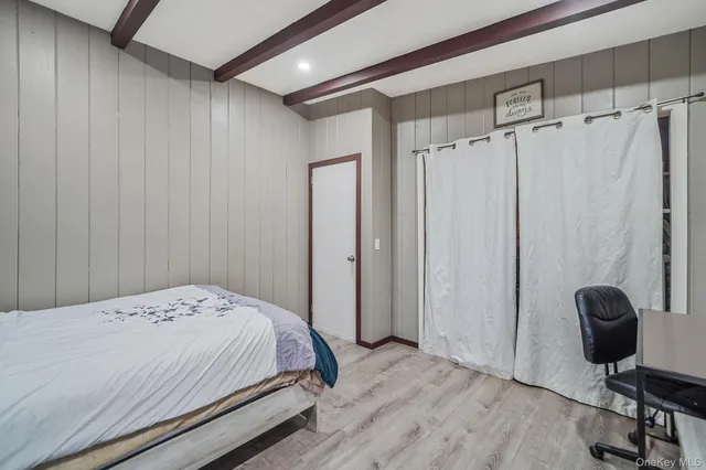 a bedroom with a bed and a chair