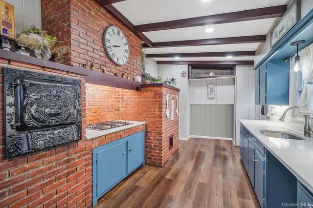a kitchen with stainless steel appliances granite countertop a stove and a wooden floors