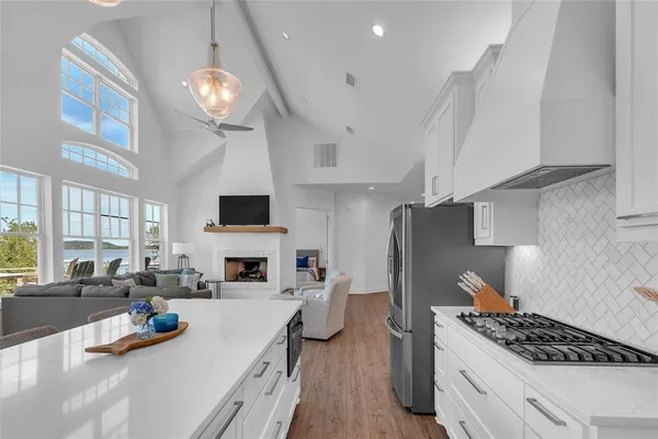 a kitchen with stainless steel appliances a stove a sink a refrigerator and cabinets