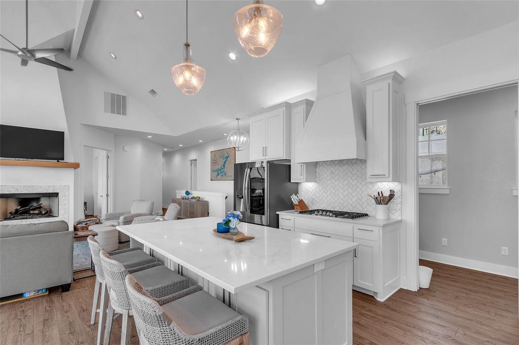 2147 Trail Rdg 2 Graford, TX 76449 - Photo 17 of 37 a kitchen with a dining table chairs and white cabinets