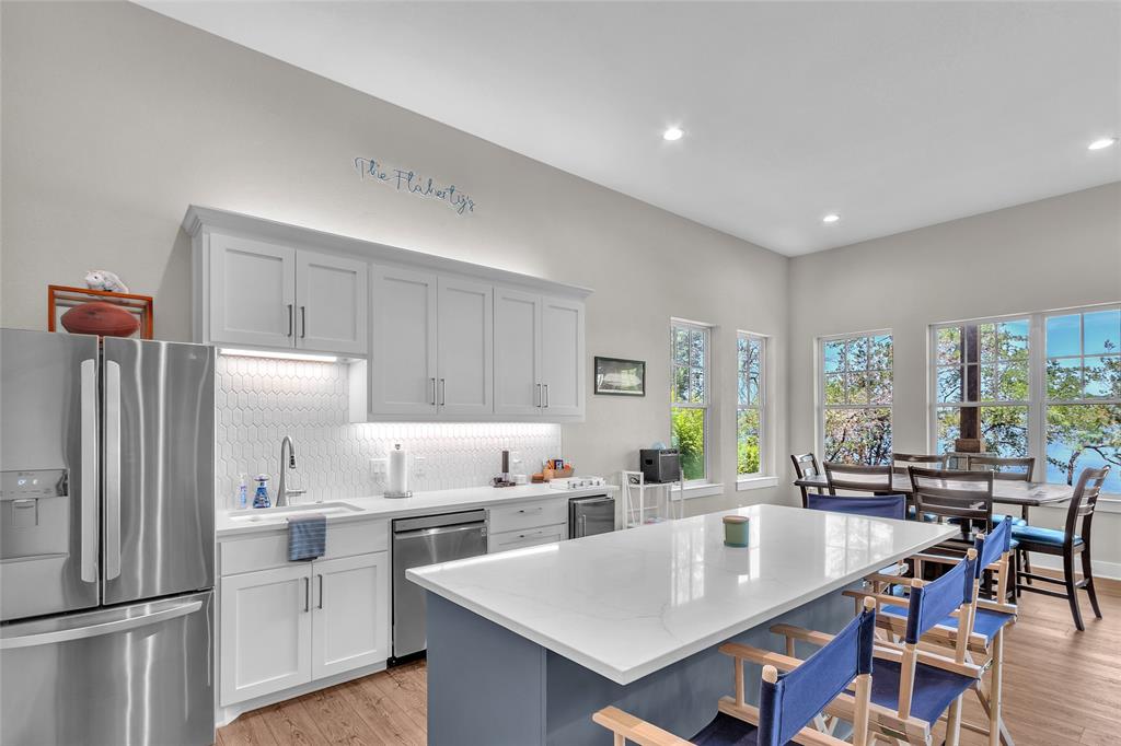 2147 Trail Rdg 2 Graford, TX 76449 - Photo 19 of 37 a large kitchen with a table chairs and refrigerator