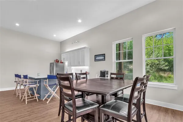 a view of a dining room with furniture and wooden floor