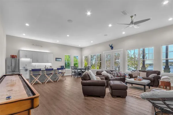 a living room with furniture wooden floor and a large window