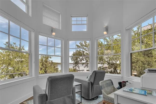 a view of a dining room with furniture large windows and wooden floor