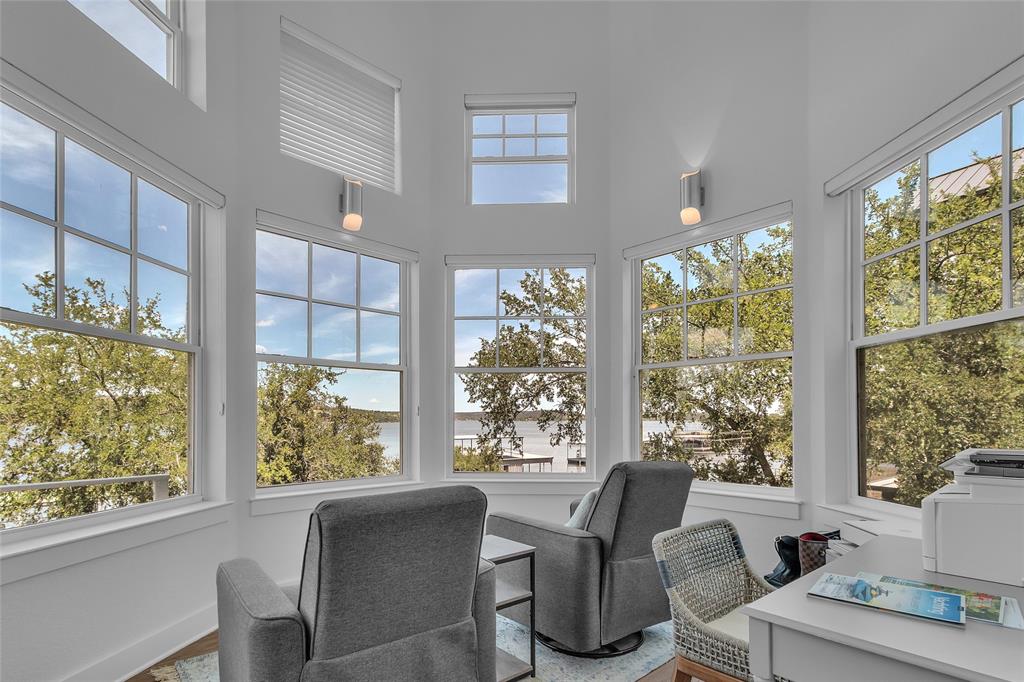 2147 Trail Rdg 2 Graford, TX 76449 - Photo 23 of 37 a view of a dining room with furniture large windows and wooden floor