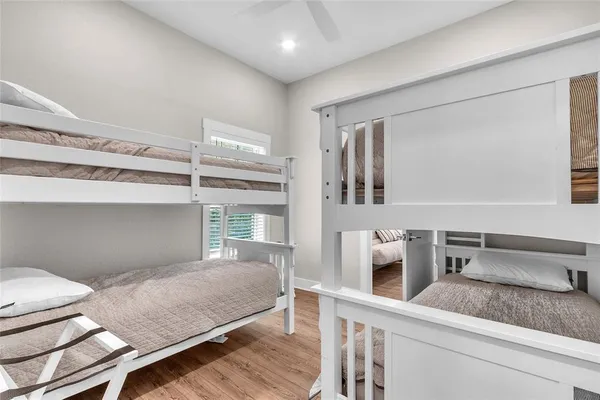 a en suite bathroom with a granite countertop sink and a mirror
